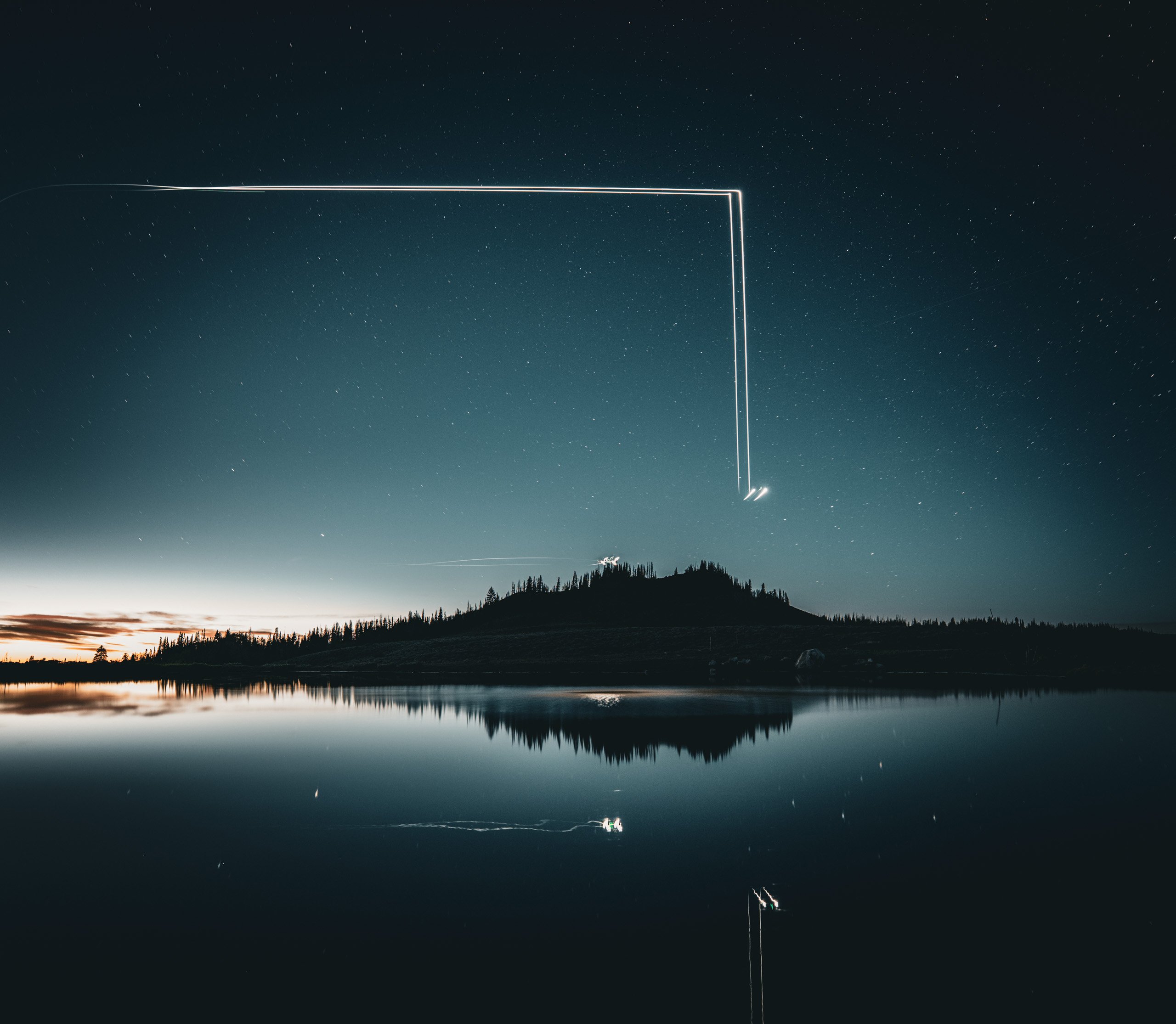 Light rectangle traced above a still night lake